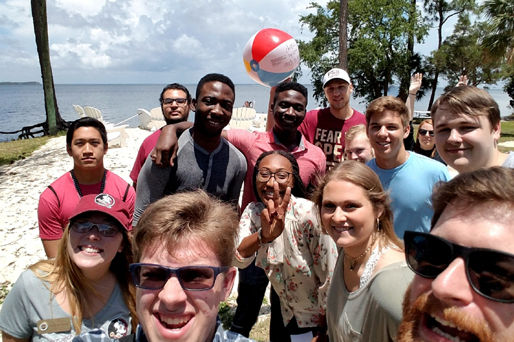 "group of students having fun at the beach"