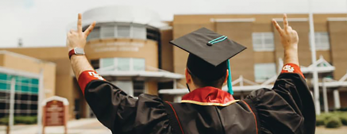 Graduate in front of FSU Panama City