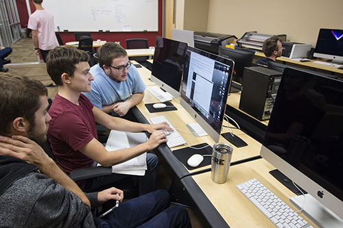 students working with a Mac