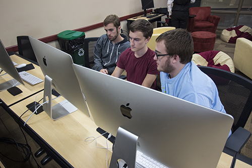 students working with a Mac