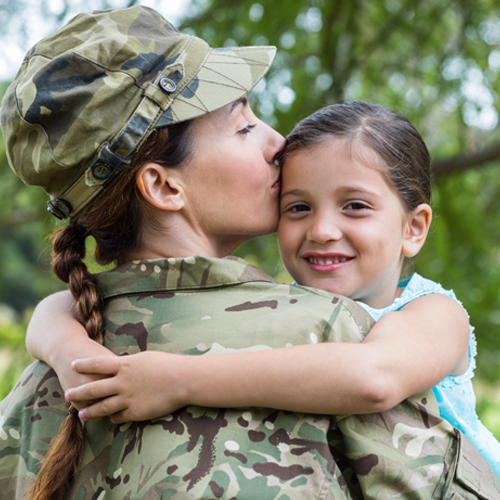 "female soldier holding child"