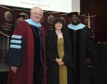 Student robed, then signs Freshmen Book