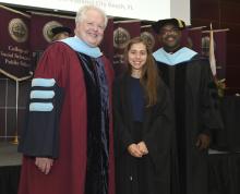 Student robed, then signs Freshmen Book