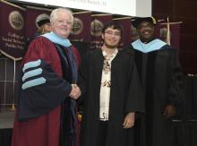 Student robed, then signs Freshmen Book