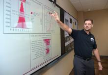 Male SE faculty at smart board in classroom