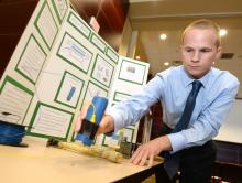 Male student exhibiting ECE Senior Design Project